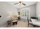 Bright office space with neutral walls, a ceiling fan, plantation shutters and comfortable seating at 12505 Garden Tree Ln, Raleigh, NC 27614