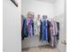 Spacious walk-in closet with built-in shelving and hanging rods for organized storage at 12505 Garden Tree Ln, Raleigh, NC 27614