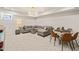 Finished basement features a gray sectional sofa and a card table with chairs at 129 Ruskin Dr, Chapel Hill, NC 27516