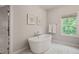 Bright bathroom with large soaking tub, marble floors, and neutral wall color at 129 Ruskin Dr, Chapel Hill, NC 27516