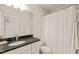 Simple bathroom with a white shower curtain, large mirror, and granite countertop at 129 Ruskin Dr, Chapel Hill, NC 27516