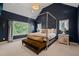 Bedroom with a four-poster bed, high ceilings, a large window, and stylish decor at 129 Ruskin Dr, Chapel Hill, NC 27516