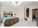 This bedroom features a large bed, industrial design elements, sitting nook, and ensuite bath at 129 Ruskin Dr, Chapel Hill, NC 27516