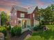 Charming red two-story home with landscaped yard and inviting porch, perfect for outdoor living at 129 Ruskin Dr, Chapel Hill, NC 27516