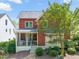 Attractive two-story home with a well-maintained lawn, mature tree, and inviting front porch at 129 Ruskin Dr, Chapel Hill, NC 27516