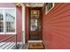 Inviting front door featuring glass panes, a stylish light fixture, and a 'hello' welcome mat at 129 Ruskin Dr, Chapel Hill, NC 27516