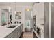 Modern kitchen with stainless steel appliances, including double ovens, and plenty of natural light at 129 Ruskin Dr, Chapel Hill, NC 27516