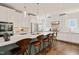 Bright kitchen featuring white cabinets, stainless steel appliances, and a large island with seating at 129 Ruskin Dr, Chapel Hill, NC 27516