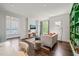 Cozy living room features neutral decor, large windows, and modern furnishings at 129 Ruskin Dr, Chapel Hill, NC 27516