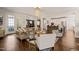 Open concept living room with hardwood floors flows into a spacious dining area and modern kitchen at 129 Ruskin Dr, Chapel Hill, NC 27516