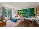 Bright living room with hardwood floors, a large green bookshelf, and stylish decor at 129 Ruskin Dr, Chapel Hill, NC 27516