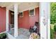 Inviting front porch with a rocking chair, stone floor, and red wood siding at 129 Ruskin Dr, Chapel Hill, NC 27516