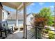 Charming porch with stone flooring, rocking chair, and views of lush greenery on a sunny day at 129 Ruskin Dr, Chapel Hill, NC 27516