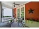 Cozy outdoor porch with a comfortable sofa, elegant decor, and a ceiling fan at 129 Ruskin Dr, Chapel Hill, NC 27516
