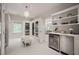 Bright walk-in closet with glass doors, custom shelving, wine cooler, and beverage center at 129 Ruskin Dr, Chapel Hill, NC 27516