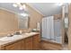 Bathroom featuring double sinks, wooden cabinetry, and a shower-tub combo with curtain at 130 S Creek Dr, Louisburg, NC 27549