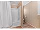 Bathroom with tiled walls, shower-tub combination, and safety features at 130 S Creek Dr, Louisburg, NC 27549