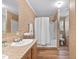 Bathroom featuring tiled walls, single sink, and shower-tub combo with accessibility features at 130 S Creek Dr, Louisburg, NC 27549
