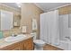 Bathroom with a shower-tub combo, vinyl flooring, and vanity with laminate countertop at 130 S Creek Dr, Louisburg, NC 27549