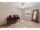 Bedroom featuring neutral walls and carpet, desk with chair, and large mirror at 130 S Creek Dr, Louisburg, NC 27549