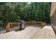 Outdoor living on a spacious wooden deck with a stainless steel grill and wooded views at 130 S Creek Dr, Louisburg, NC 27549