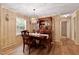 Elegant dining room with rich wood furniture, a decorative chandelier, and wood-look floors at 130 S Creek Dr, Louisburg, NC 27549