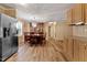 Open dining area with dark wood furniture, wood-look floors, and stainless refrigerator at 130 S Creek Dr, Louisburg, NC 27549