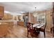 Open dining area with a chandelier, wood floors, and a view of the kitchen at 130 S Creek Dr, Louisburg, NC 27549