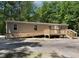 Accessible single-story home with neutral siding, featuring a large wooden ramp and stairs for easy entry at 130 S Creek Dr, Louisburg, NC 27549