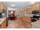 Spacious kitchen with stainless appliances and an adjacent dining area with a dark wood table at 130 S Creek Dr, Louisburg, NC 27549