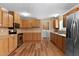 Traditional style kitchen with wood cabinets, stainless appliances, and wood-look flooring at 130 S Creek Dr, Louisburg, NC 27549