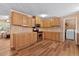 Bright kitchen with wood cabinets, laminate countertops, stainless appliances, and adjoining laundry room at 130 S Creek Dr, Louisburg, NC 27549