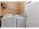 Laundry room with washer and dryer, shelving and exterior door to the backyard at 130 S Creek Dr, Louisburg, NC 27549