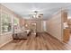 Spacious living room featuring wood-look floors, a daybed sofa, and ample natural light at 130 S Creek Dr, Louisburg, NC 27549