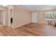Bright living room featuring vinyl plank flooring and a view towards the entry door and hallway at 130 S Creek Dr, Louisburg, NC 27549