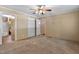 Spacious main bedroom featuring tan wall paneling, carpet, and a stylish ceiling fan at 130 S Creek Dr, Louisburg, NC 27549