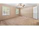 Main bedroom with neutral walls, carpeting, and multiple windows at 130 S Creek Dr, Louisburg, NC 27549