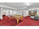 Basement recreation room featuring a billiard table and cozy seating area for entertaining and relaxation at 1325 Red Brick Rd, Garner, NC 27529