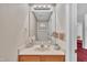 Charming half bathroom with a light wood vanity, classic mirror, and tasteful decor at 1325 Red Brick Rd, Garner, NC 27529