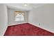 Red carpeted bedroom with a large window and neutral paint, ready for your personal touch at 1325 Red Brick Rd, Garner, NC 27529