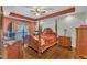Beautifully decorated bedroom featuring a four-poster bed, wooden furniture, and a tray ceiling at 1325 Red Brick Rd, Garner, NC 27529