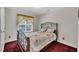 Cozy bedroom with decorative iron bed frame, matching pillows and a bright window at 1325 Red Brick Rd, Garner, NC 27529