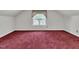 Spacious bedroom with red carpeting, light walls, and natural light from the window at 1325 Red Brick Rd, Garner, NC 27529