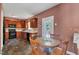 Well-equipped kitchen with wood cabinetry and a dining area, featuring a view to the outdoors at 1325 Red Brick Rd, Garner, NC 27529