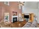 Cozy living room with a fireplace, high ceilings, hardwood floors, and comfortable seating, perfect for relaxation at 1325 Red Brick Rd, Garner, NC 27529
