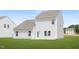 A backyard with green grass surrounding the white, vinyl sided home at 142 Benson Village Dr # 82, Benson, NC 27504