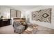 This bedroom features two stylish chairs, a decorative wall hanging, and comfortable bedding with elegant furnishings at 142 Benson Village Dr # 82, Benson, NC 27504