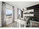 Dining space filled with natural light, modern décor, and a stylish black accent wall at 142 Benson Village Dr # 82, Benson, NC 27504