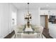 Bright dining room features a modern glass table, stylish chairs, and a contemporary chandelier at 142 Benson Village Dr # 82, Benson, NC 27504