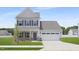 Charming two-story home with gray siding, a two-car garage, and a well-manicured lawn at 142 Benson Village Dr # 82, Benson, NC 27504